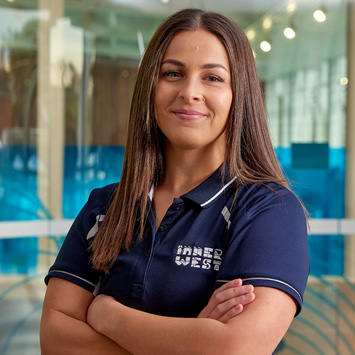 Personal trainer Samara standing with arms crossed smiling at the camera